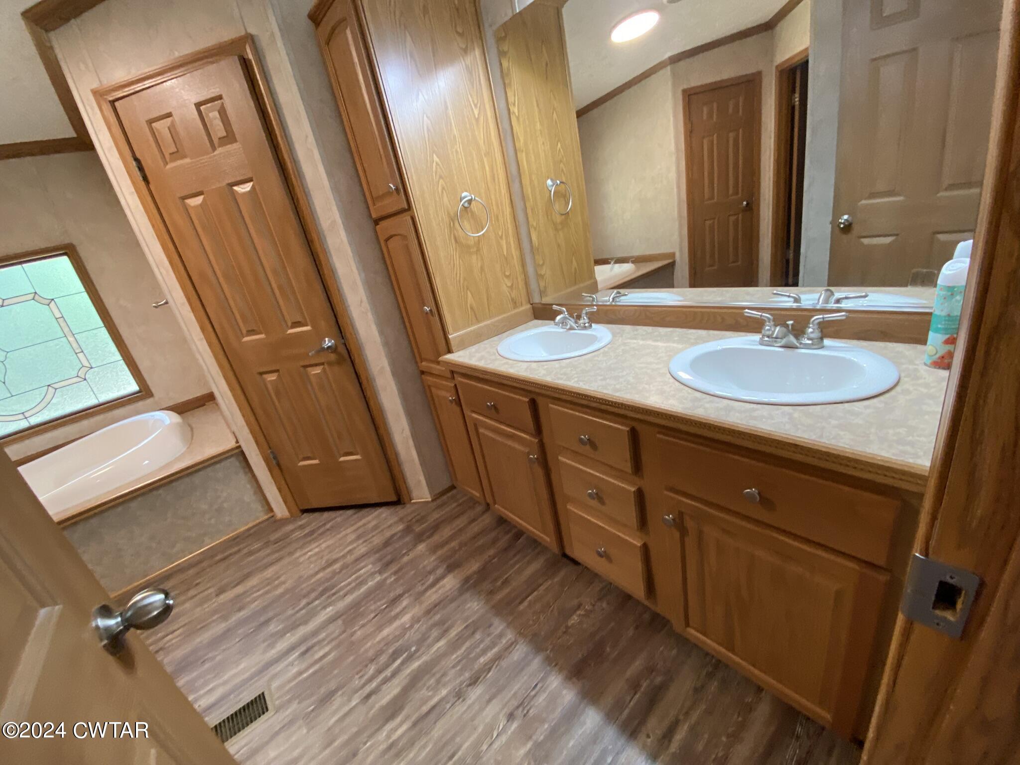 6555 Roby Road Enville, TN 38332 - Photo 10 of 22 a bathroom with a double vanity sink and a mirror