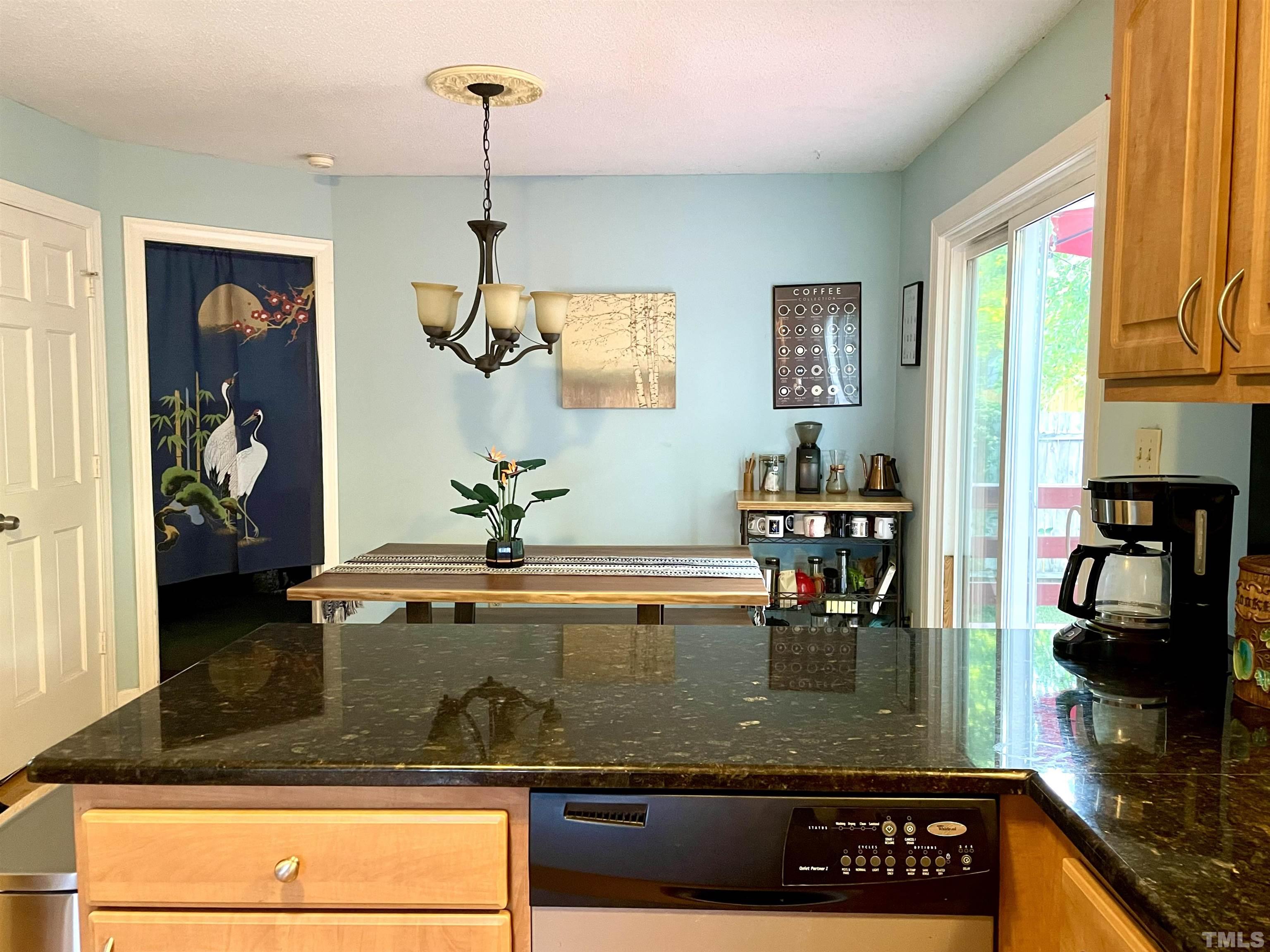 a kitchen with a refrigerator and a stove top oven