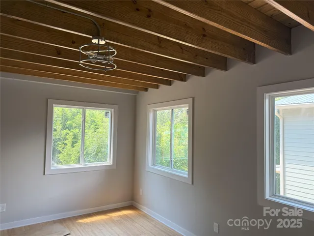 a view of room with a window and chandelier