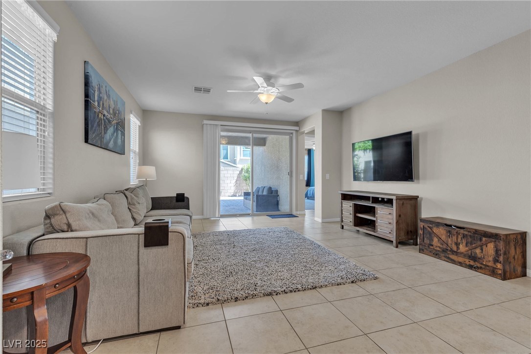9950 Coyote Echo Court Las Vegas, NV 89166 - Photo 11 of 71 Living area featuring light tile patterned flooring and a ceiling fan