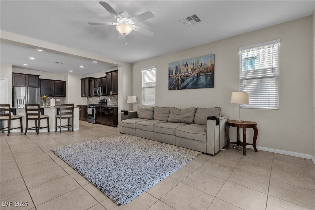 9950 Coyote Echo Court Las Vegas, NV 89166 - Photo 13 of 71 Living room featuring light tile patterned floors, ceiling fan, and recessed lighting