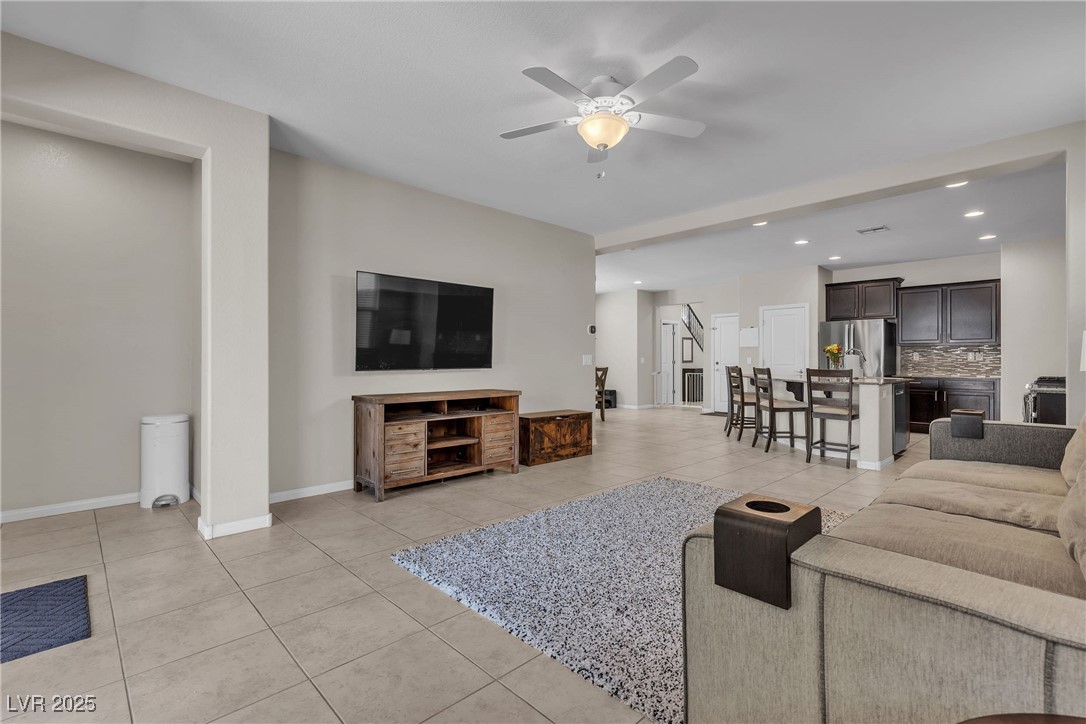 9950 Coyote Echo Court Las Vegas, NV 89166 - Photo 14 of 71 Living area with light tile patterned floors, recessed lighting, and ceiling fan