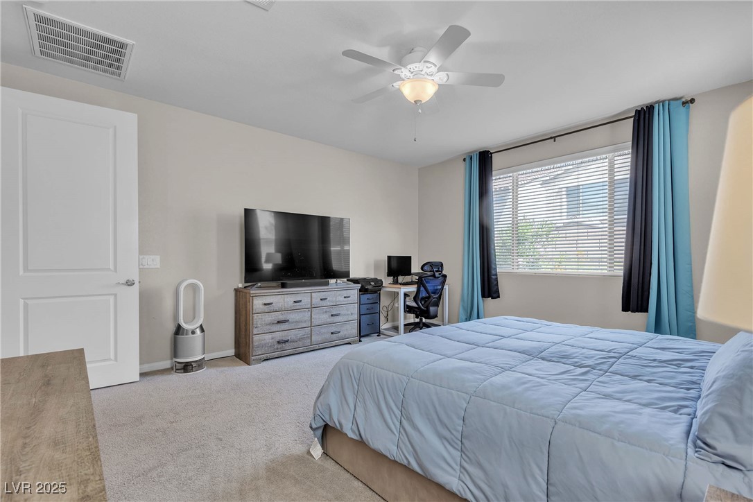 9950 Coyote Echo Court Las Vegas, NV 89166 - Photo 17 of 71 Bedroom featuring carpet and ceiling fan
