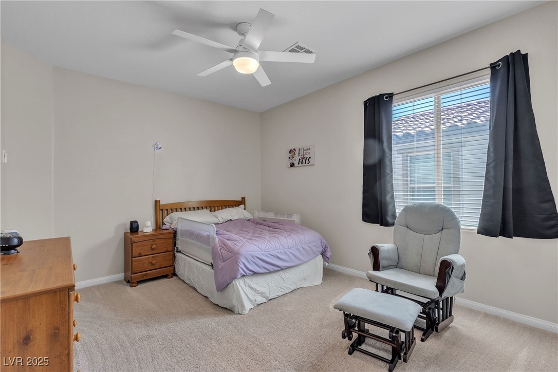 9950 Coyote Echo Court Las Vegas, NV 89166 - Photo 28 of 71 Bedroom with light carpet and ceiling fan