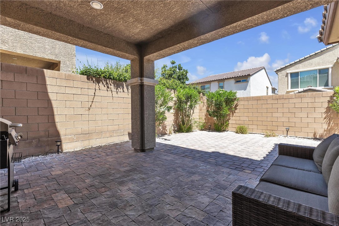 9950 Coyote Echo Court Las Vegas, NV 89166 - Photo 43 of 71 Fenced backyard featuring a patio and grilling area