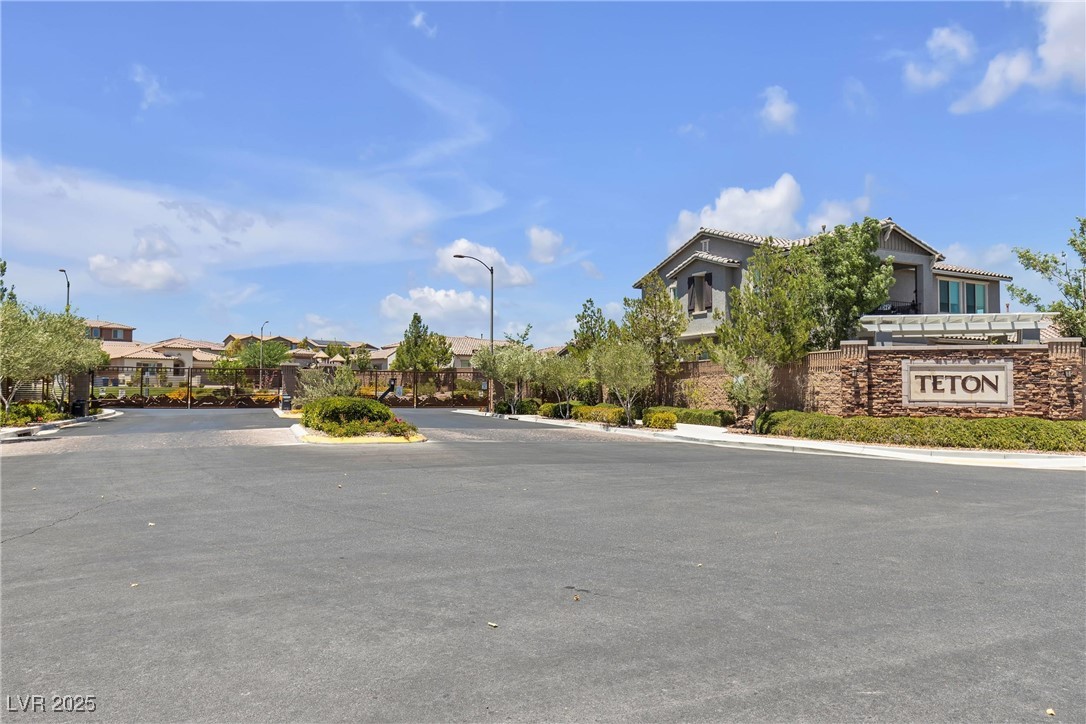 9950 Coyote Echo Court Las Vegas, NV 89166 - Photo 49 of 71 View of asphalt street with curbs, street lights, a residential view, and a gated entry