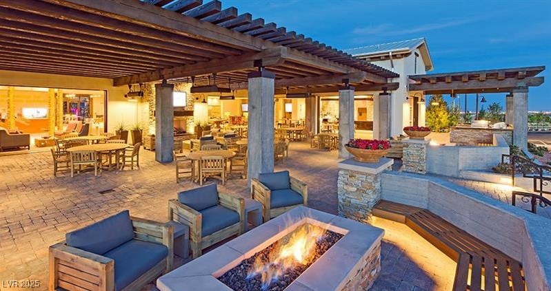 9950 Coyote Echo Court Las Vegas, NV 89166 - Photo 65 of 71 View of patio / terrace with a pergola, an outdoor fire pit, and outdoor dining area