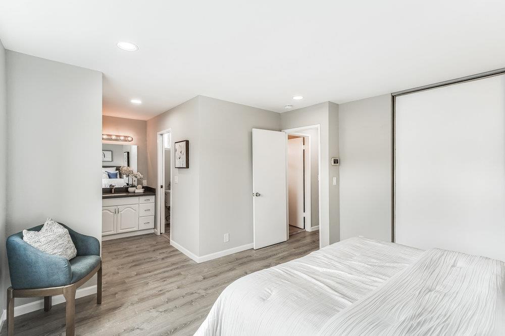 5642 Geranium Court Newark, CA 94560 - Photo 16 of 30 a spacious bedroom with a bed and a couch