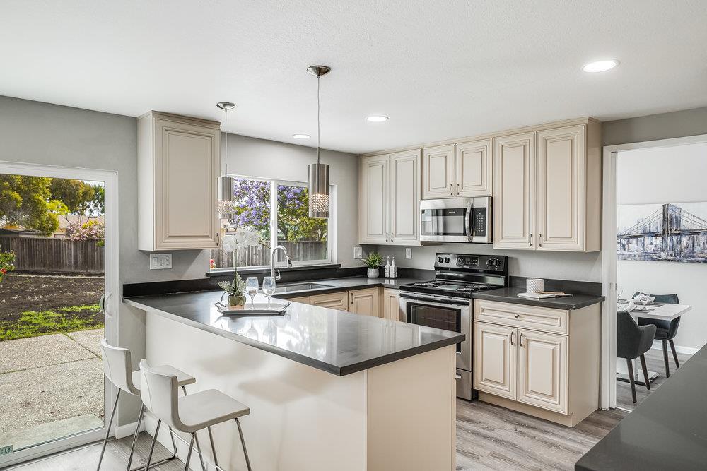 5642 Geranium Court Newark, CA 94560 - Photo 9 of 30 a kitchen with granite countertop a stove sink and cabinets