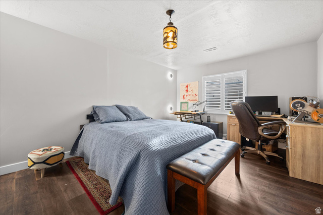 3359 Eurasian Crane Road Clinton, UT 84015 - Photo 46 of 71 Bedroom with a desk, dark wood-style floors, and a textured ceiling