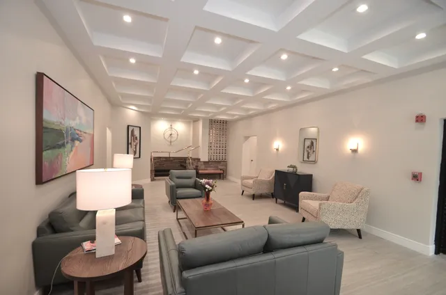 a living room with furniture and a lamp