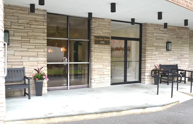a view of a street with potted plants