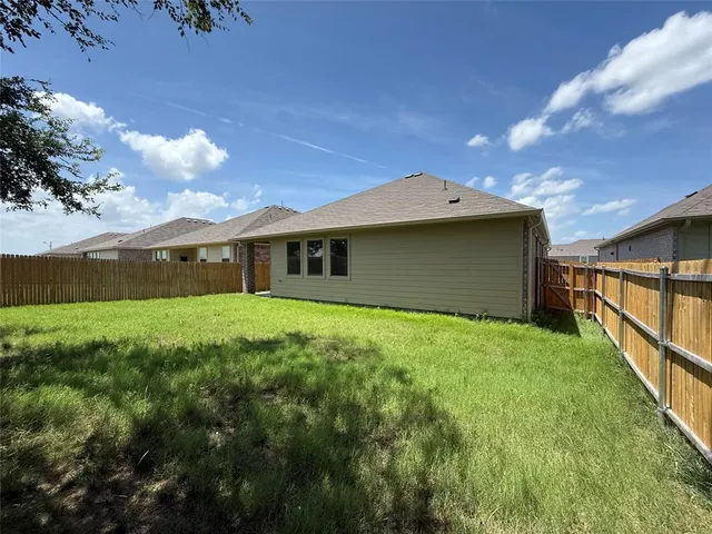 a yellow house with garden in front of it