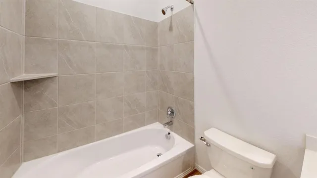 a bathroom with a bathtub and a toilet