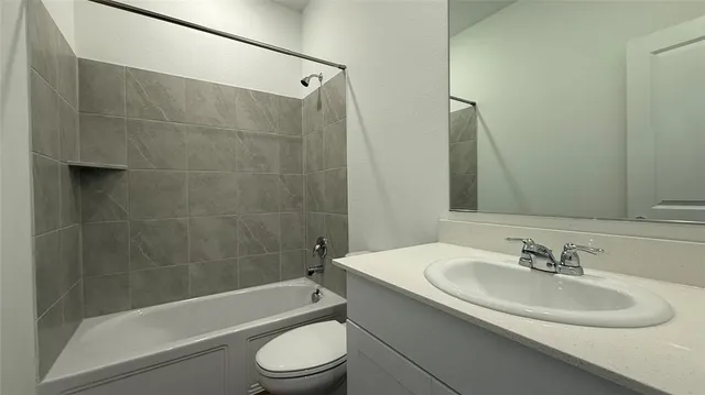 a bathroom with a sink a toilet and bathtub