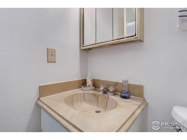 a bathroom with a sink vanity and toilet