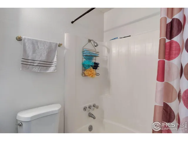 a bathroom with a toilet sink and shower
