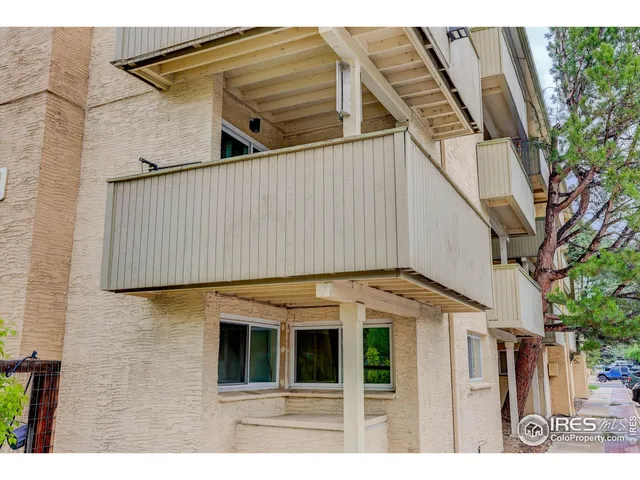 a view of small white building with large windows