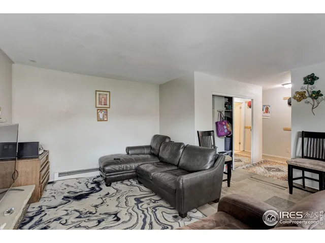 a living room with furniture and a book shelf