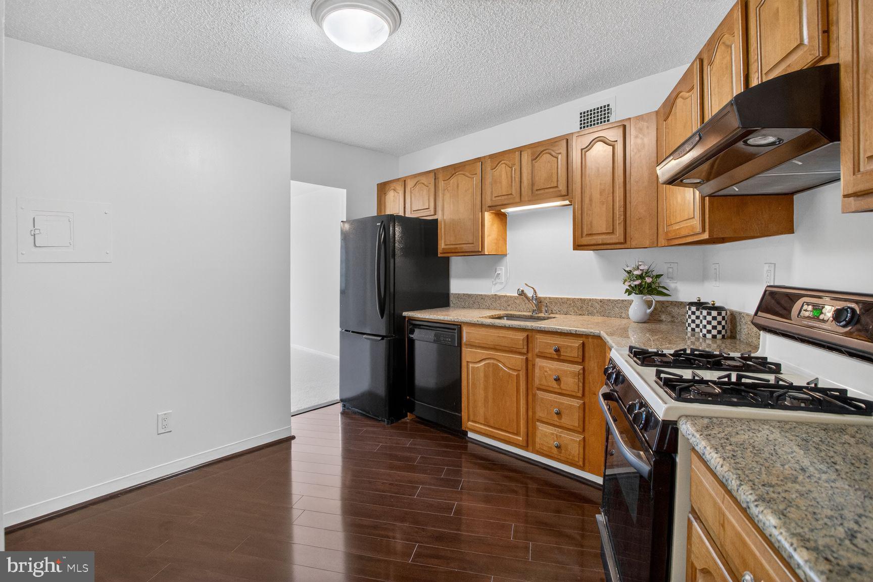 5225 Pooks Hill Road, Unit 1301N Bethesda, MD 20814 - Photo 8 of 26 a kitchen with stainless steel appliances granite countertop a refrigerator stove and sink