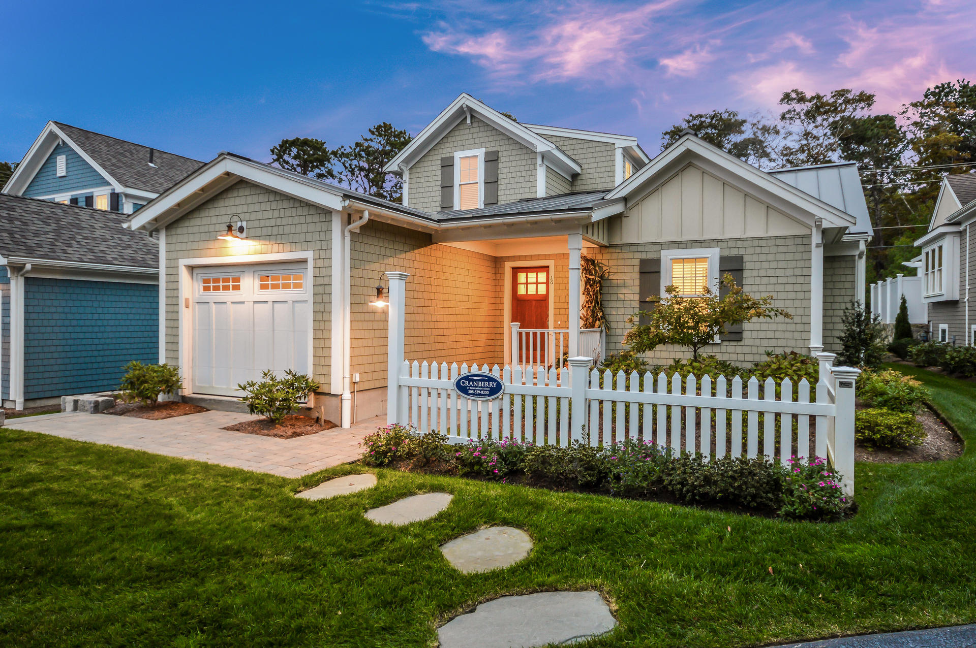 a front view of a house with a yard and fence