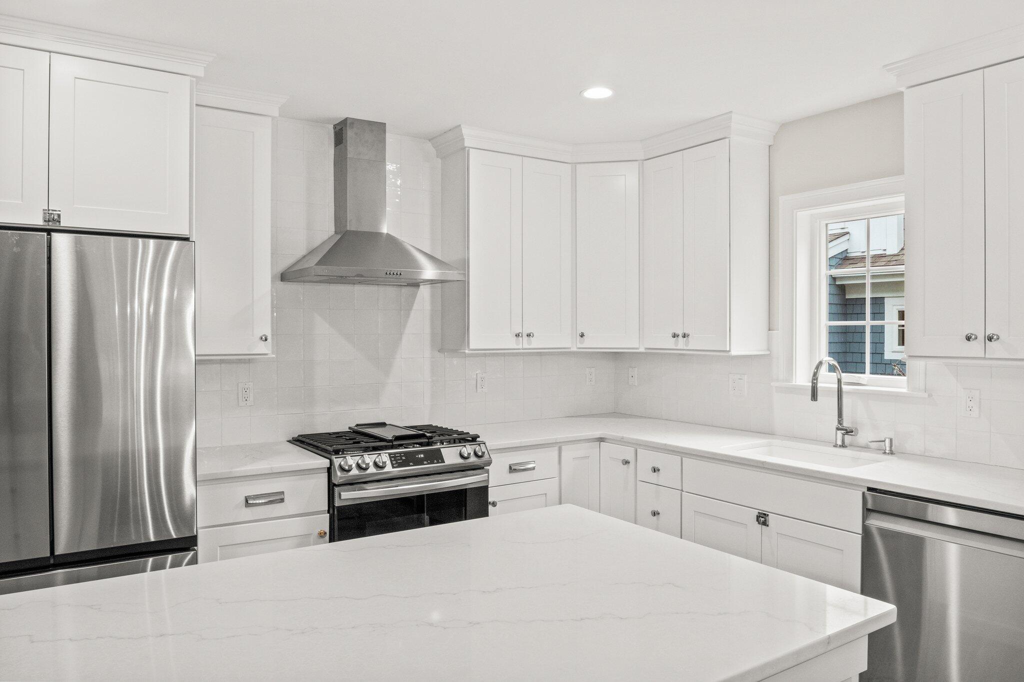 11 Azalea Lane Mashpee, MA 02649 - Photo 12 of 41 a kitchen with white cabinets and white appliances
