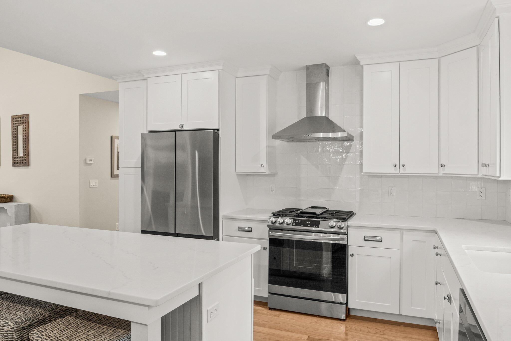 11 Azalea Lane Mashpee, MA 02649 - Photo 13 of 41 a kitchen with stainless steel appliances a refrigerator stove and white cabinets