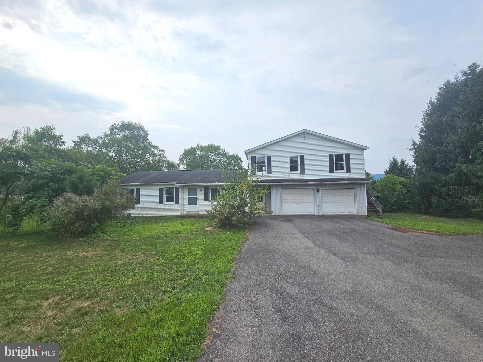 1093 Powells Valley Road Halifax, PA 17032 - Photo 1 of 10 a view of house with a big yard and large trees