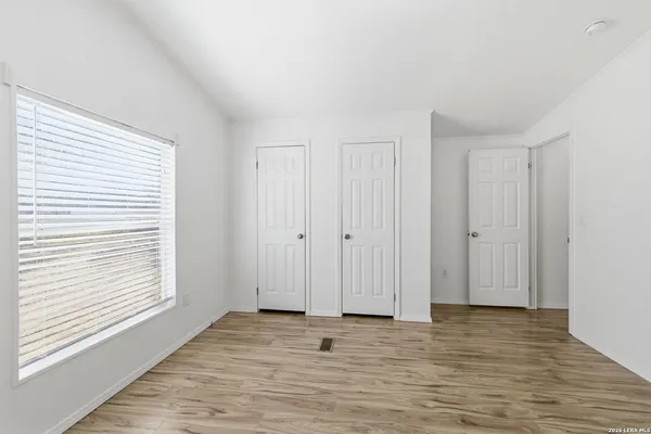 a view of wooden floor and windows in a room
