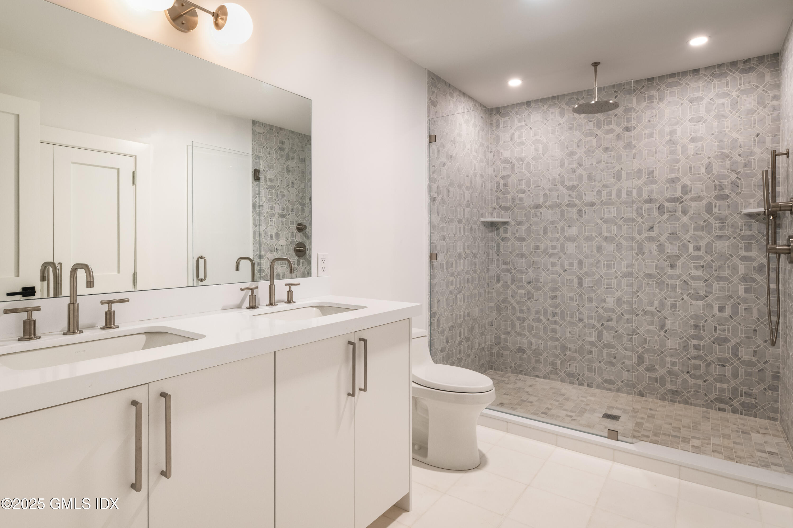 11 Winterset Road Greenwich, CT 06830 - Photo 12 of 14 a bathroom with a double vanity sink toilet and shower