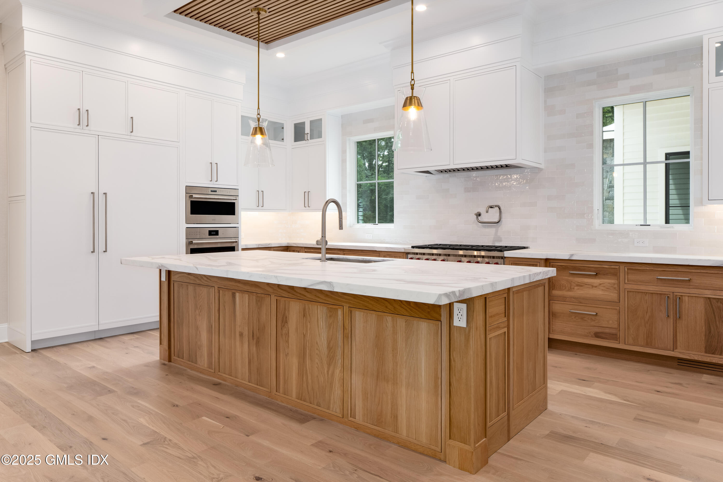 11 Winterset Road Greenwich, CT 06830 - Photo 4 of 14 a kitchen with stainless steel appliances granite countertop a sink a stove a refrigerator and island with wooden floor
