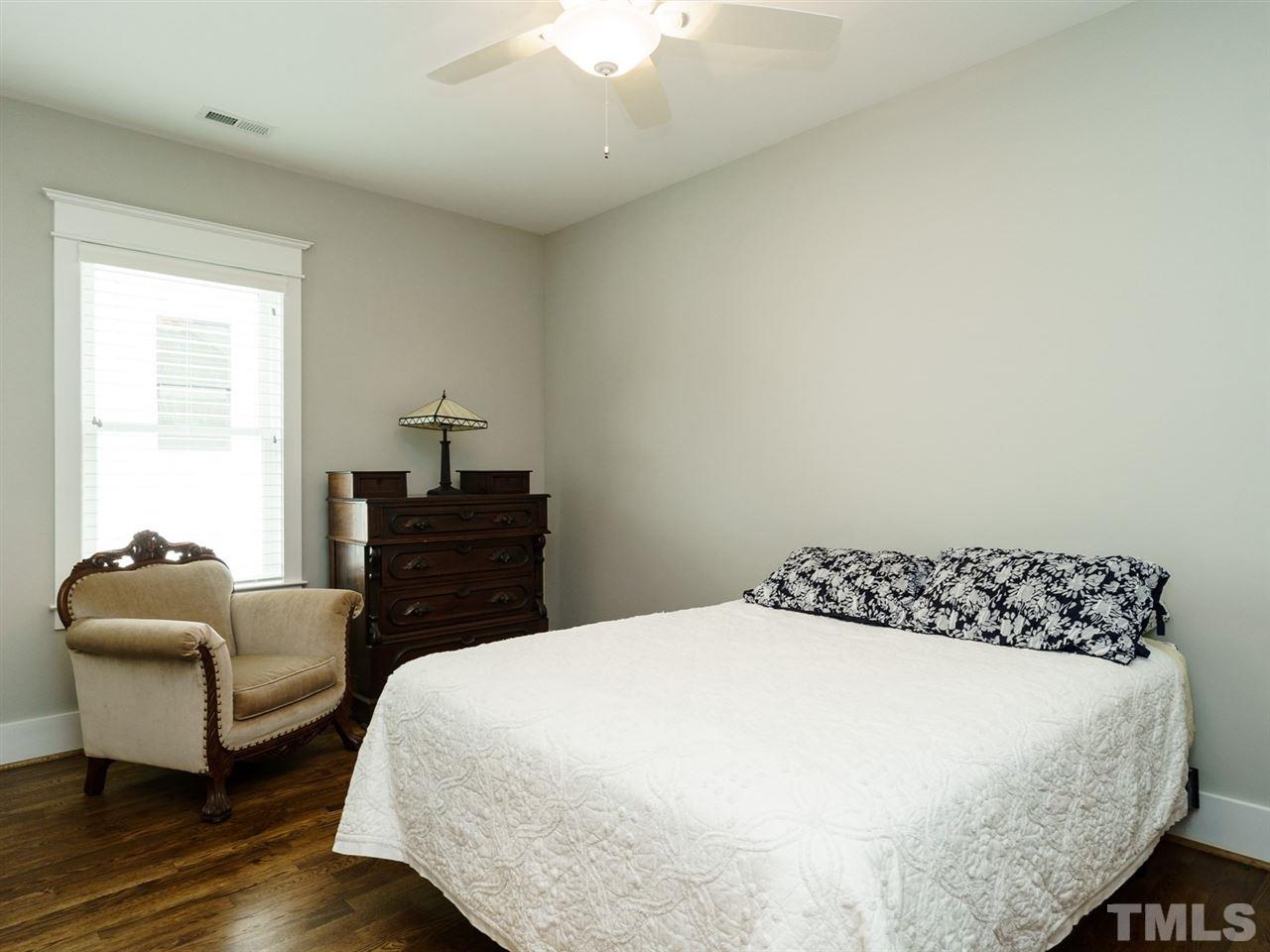 710 Virginia Avenue Raleigh, NC 27604 - Photo 17 of 25 a bedroom with a bed and a couch