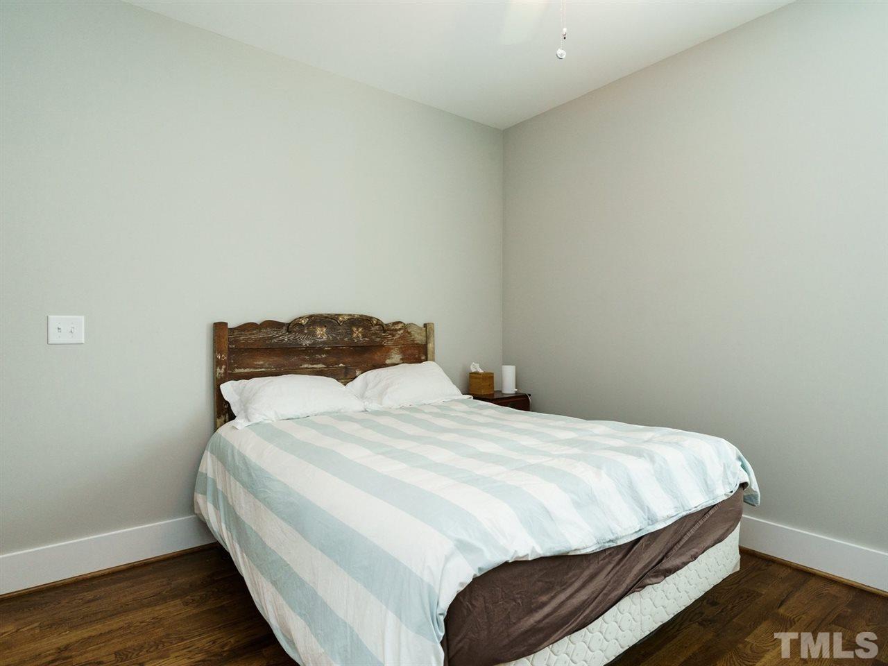 710 Virginia Avenue Raleigh, NC 27604 - Photo 18 of 25 a bedroom with a bed and wooden floor