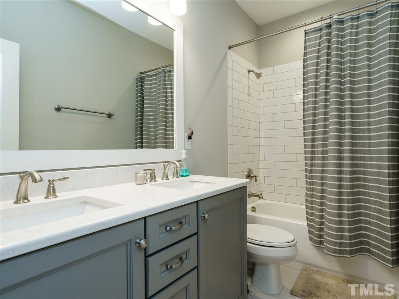 710 Virginia Avenue Raleigh, NC 27604 - Photo 19 of 25 a bathroom with a sink a toilet and shower