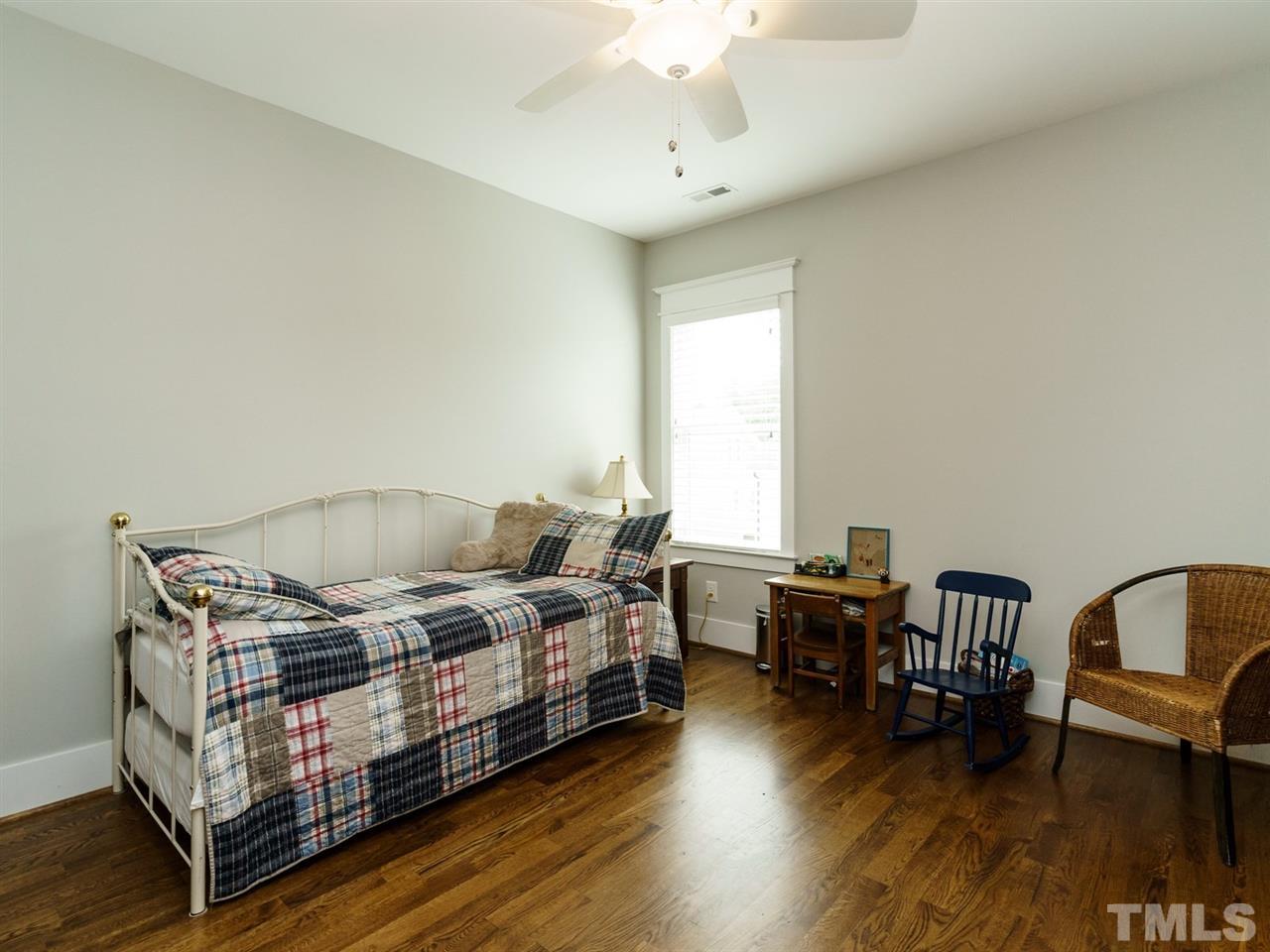 710 Virginia Avenue Raleigh, NC 27604 - Photo 20 of 25 a bedroom with furniture and a wooden floor