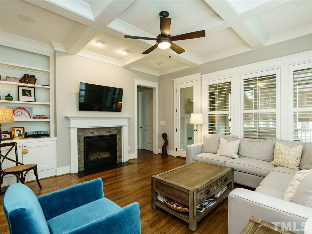 710 Virginia Avenue Raleigh, NC 27604 - Photo 9 of 25 a living room with furniture a flat screen tv and a fireplace