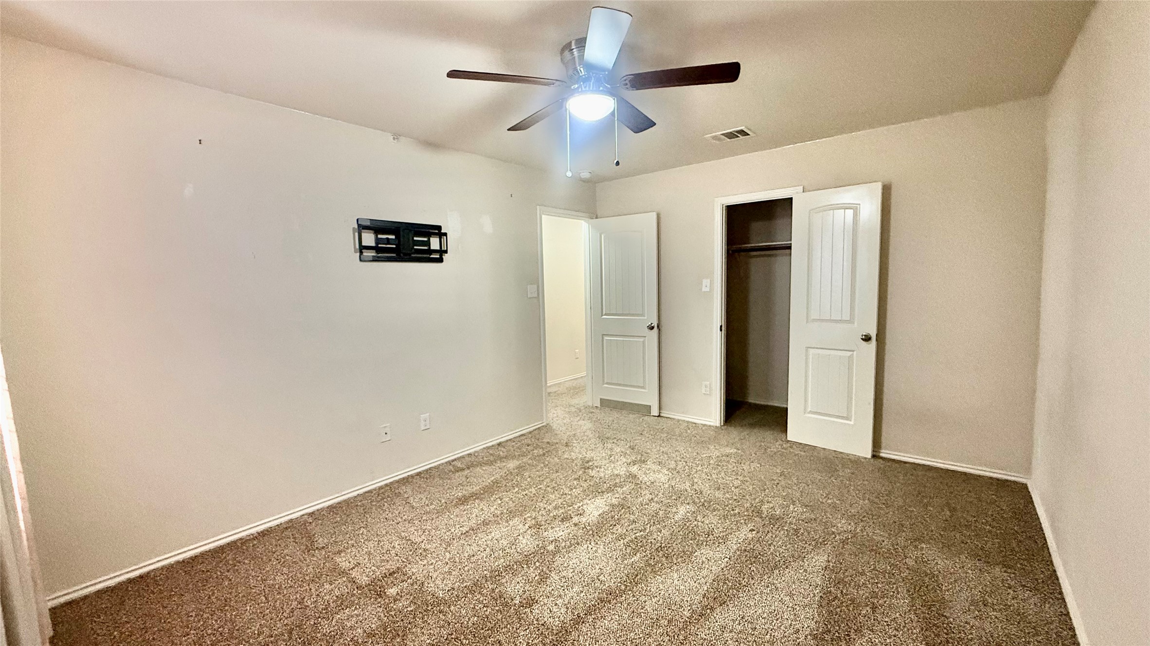 18309 Wind Tree Lane Elgin, TX 78621 - Photo 25 of 29 Soft carpeting pairs with smooth neutral walls in this versatile secondary bedroom space.
