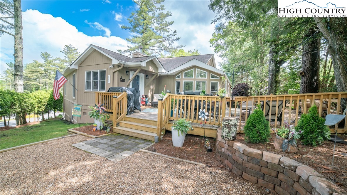 a front view of a house with a garden and plants