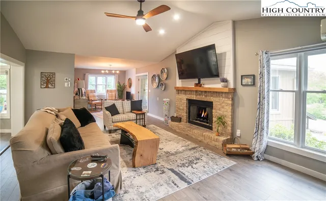 a living room with furniture fireplace and flat screen tv