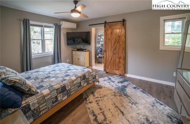 a bedroom with a bed closet and flat tv screen