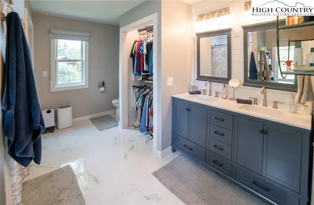 a hall with a sink vanity and a mirror