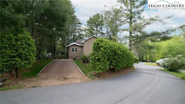 a view of a house with a yard and garage