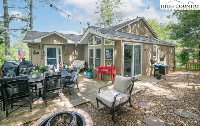 a view of a house with backyard porch and sitting area