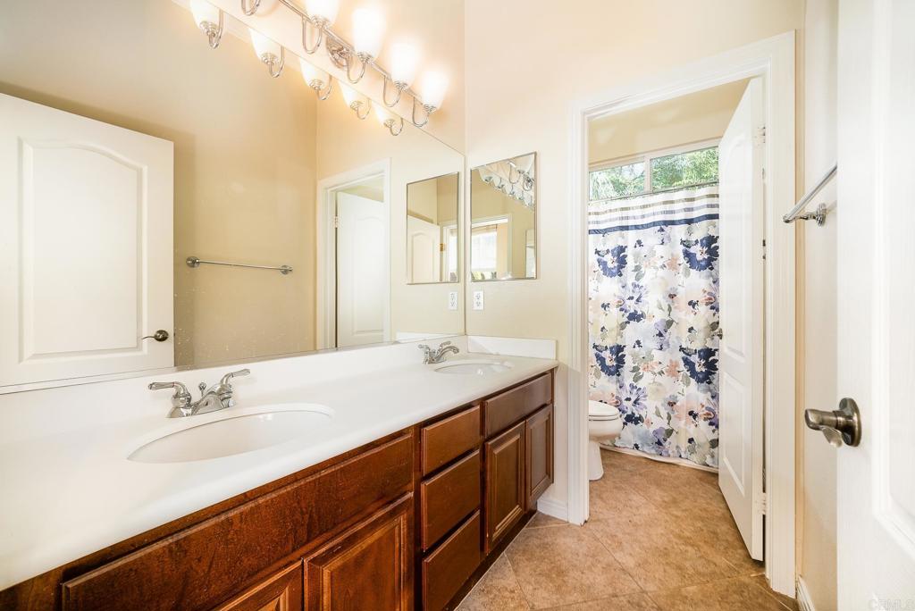 1075 Crimson Drive San Marcos, CA 92069 - Photo 21 of 74 a spacious bathroom with double vanity and a mirror