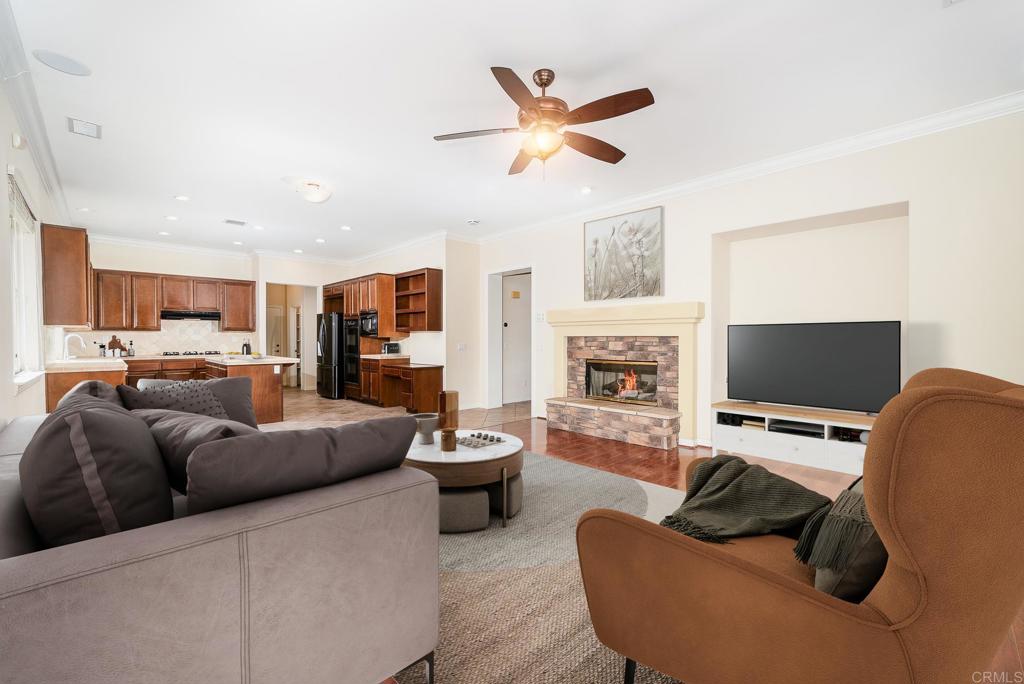 1075 Crimson Drive San Marcos, CA 92069 - Photo 24 of 74 a living room with furniture kitchen view and a fireplace