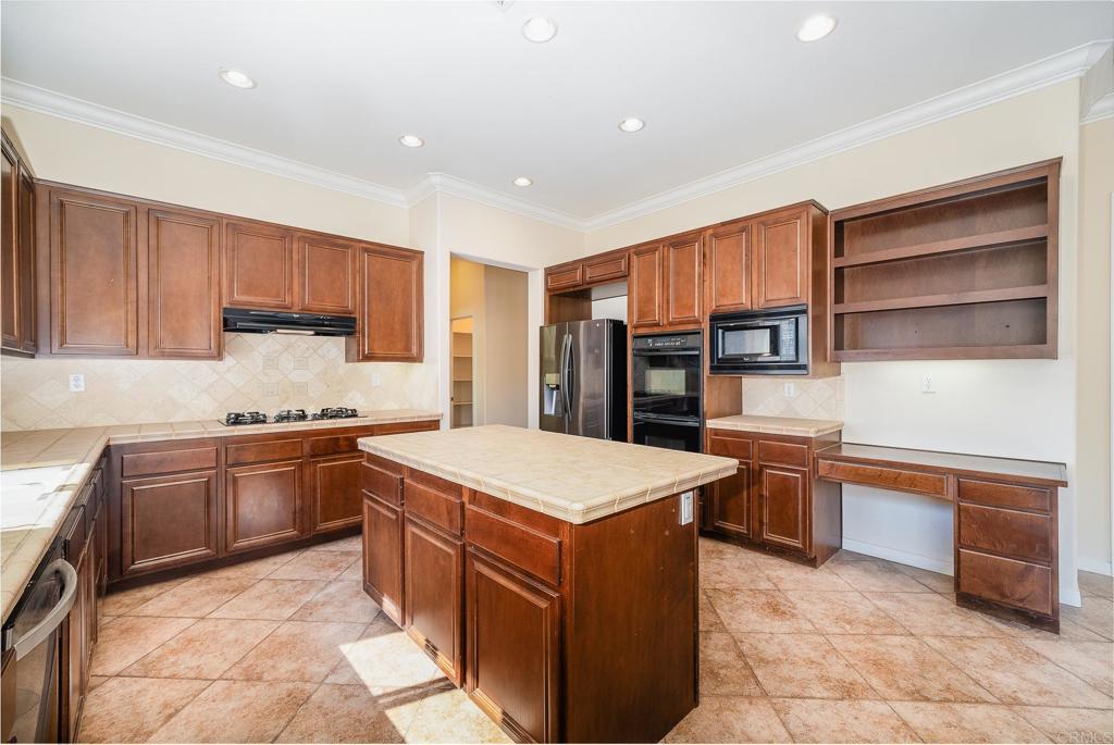 1075 Crimson Drive San Marcos, CA 92069 - Photo 29 of 74 a kitchen with stainless steel appliances granite countertop a refrigerator and a stove top oven