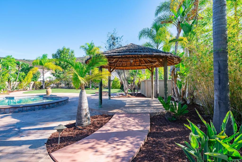 1075 Crimson Drive San Marcos, CA 92069 - Photo 50 of 74 a view of a backyard with table and chairs under an umbrella