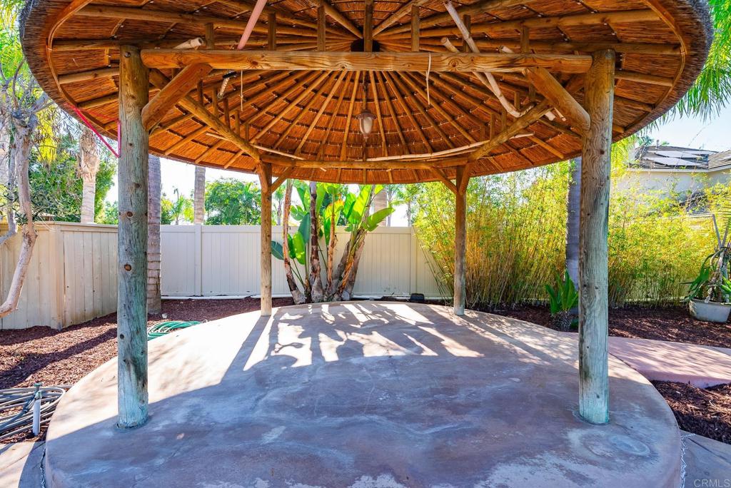 1075 Crimson Drive San Marcos, CA 92069 - Photo 51 of 74 a backyard of a house with table and chairs under an umbrella