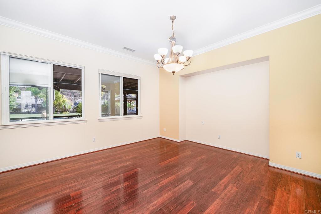 1075 Crimson Drive San Marcos, CA 92069 - Photo 9 of 74 a view of an empty room with wooden floor and a window