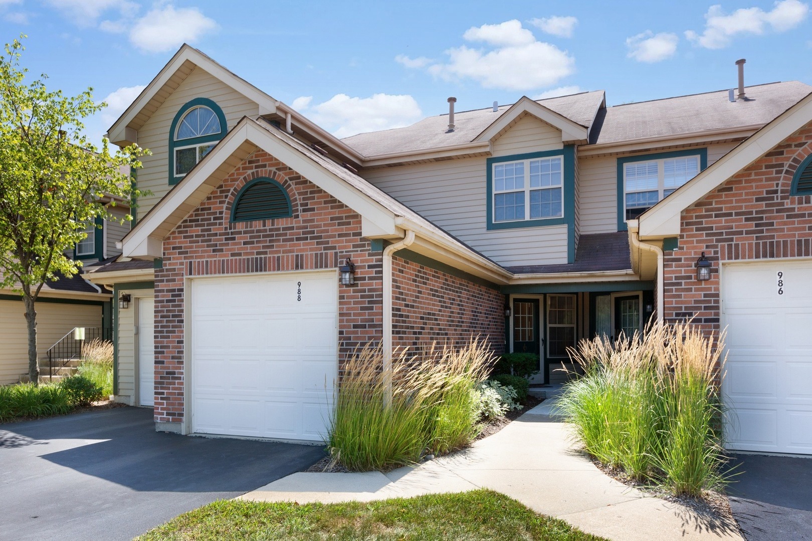 988 Ridgefield Lane Wheeling, IL 60090 - Photo 1 of 18 a front view of a house with a yard